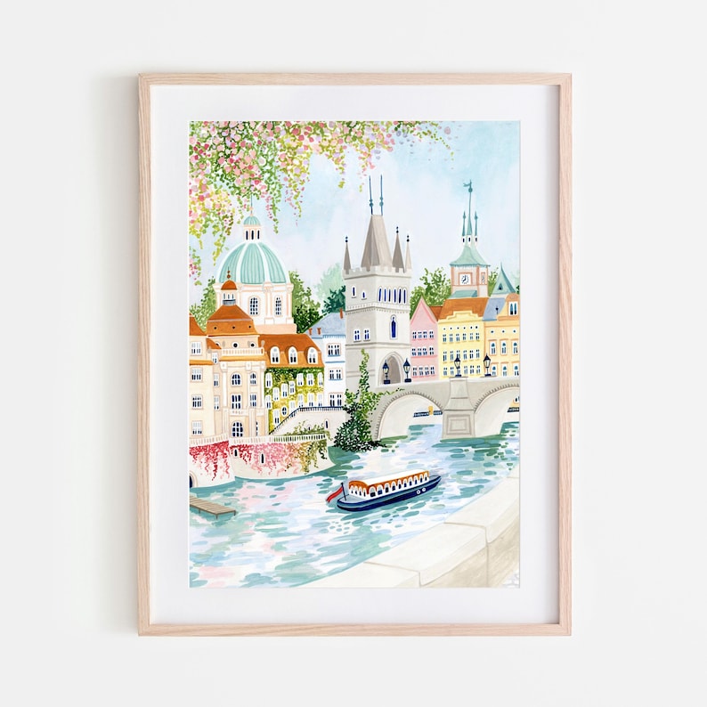 May include: A watercolor painting of a cityscape with a bridge over a river. The buildings are colorful and have a European style. There are trees and flowers in the foreground. A small boat is in the river.