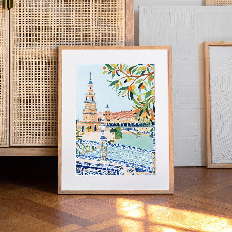 May include: A framed illustration of a building with a tall tower, surrounded by a tiled fence and a tree with orange fruit. The building is painted in shades of orange, yellow, and brown, while the fence is blue and white. The background is a light blue sky.