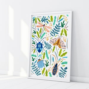 May include: A white framed print with a colorful illustration of insects and foliage. The print features a blue and green beetle, a yellow and black beetle, a dragonfly, and a moth.