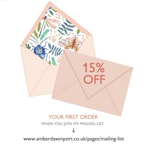 May include: A pink envelope with a floral pattern on the inside flap. The envelope is open and the flap is folded back. The text on the envelope reads "15% OFF YOUR FIRST ORDER WHEN YOU JOIN MY MAILING LIST" and includes a link to the website: www.amberdavenport.co.uk/pages/mailing-list.