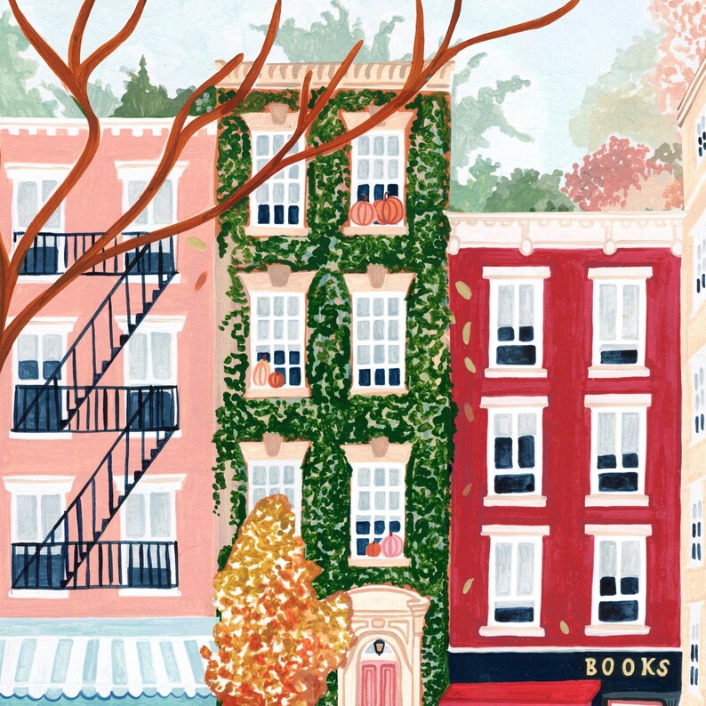 May include: A colourful illustration of buildings with white-framed windows. One building is covered in green vines and decorated with pumpkins. A red building has a sign that says "BOOKS". A tree with orange leaves is in the foreground.