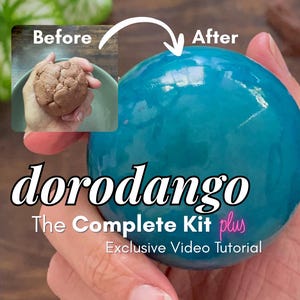 May include: A smooth, glossy teal sphere held in a hand, contrasted with an inset image of a rough, brown clay ball labelled Before and After. Text reads: dorodango The Complete Kit plus Exclusive Video Tutorial in white and pink.