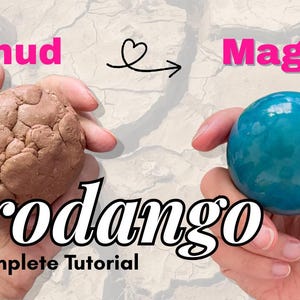 K&ouml;nnte beinhalten: Ein Bild, das eine Verwandlung von einem braunen, strukturierten Ball mit der Aufschrift &bdquo;Schlamm&ldquo; in eine glatte, blaue Kugel mit der Aufschrift &bdquo;Magie&ldquo; zeigt. Der Text &bdquo;dorodango&ldquo; und &bdquo;The Complete Tutorial&ldquo; sind ebenfalls sichtbar.