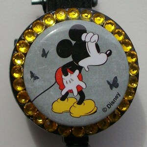 Vintage grey Mickey Mouse badge reel with yellow rhinestones