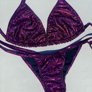 May include: Purple glitter bikini with a triangle top and a high-cut bottom.