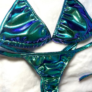 Pode incluir: Um biquíni verde e roxo iridescente com um top halter e uma parte inferior de corte alto.