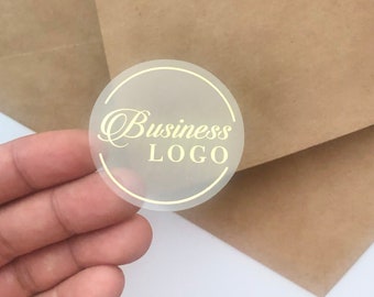 May include: A clear round sticker with a gold outline and the text "Business LOGO" in gold lettering.