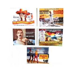 May include: A collection of five vintage movie posters. The posters are for the films "The Magnificent Two", "Summer Holiday", "Clockwise", "Thunderbirds are Go", and "Wonderful Life".