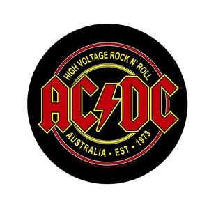 May include: A black and yellow circle with the words "High Voltage Rock 'n' Roll" around the edge. Inside the circle is the word "AC/DC" in red letters with a yellow lightning bolt. The words "Australia Est. 1973" are below the word "AC/DC".