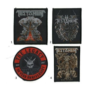 May include: Four black patches featuring the band name "TESTAMENT" in white. The patches display various graphics, including a skull, a shield, and figures. One patch is circular with "THE LEGACY" and "30 YEAR ANNIVERSARY" text.