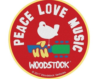 May include: A red circle with a yellow border features a white dove perched on a guitar with the words "Peace Love Music" around the outside and "Woodstock" at the bottom. The text "© 2017 Woodstock Ventures." is at the bottom.