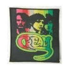 May include: A black and green embroidered patch with the word "Grey" in a stylized font. The patch features a rainbow stripe design and three faces of people.