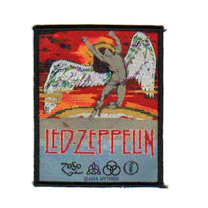 May include: A black and silver embroidered patch featuring a winged figure with a red, orange, and yellow sunset background. The text "LED ZEPPELIN" is printed in red below the figure. The patch also includes the band's logo and the text "©2004 MYTPEP".
