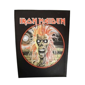 May include: Black square featuring the Iron Maiden logo in red and white. The image includes a circular illustration of a zombie-like figure with orange hair and a red outline. The background is a night scene.