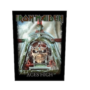 May include: A black and white graphic t-shirt featuring a skull wearing a pilot's helmet and goggles in a plane cockpit. The text "Iron Maiden" and "Aces High" are printed on the shirt.
