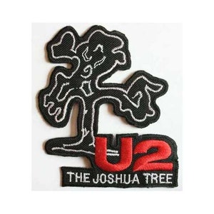 May include: Black and white embroidered patch of a tree with the words "U2 The Joshua Tree" in red and white lettering.