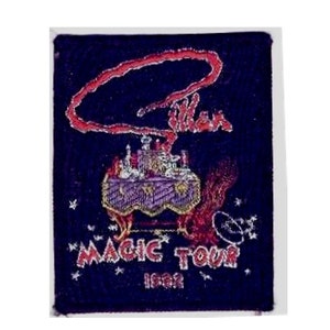 May include: A dark blue patch with a red and white image of a magic show stage with a magician's hat and the text "Magic Tour 1982".