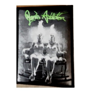 May include: Black and white image of two women sitting on a rocking chair. The image is framed with a black border and the text "Janie's Addiction" is written in green at the top of the image.