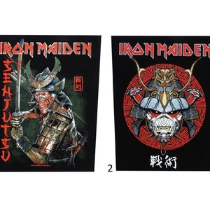 May include: Two black Iron Maiden patches with a samurai warrior design. The first patch features a samurai warrior holding a sword with the text "SENJUTSU" in red. The second patch features a samurai warrior's helmet with the text "戦術" in red.