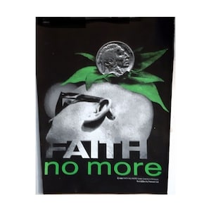 May include: Black and green Faith No More band t-shirt featuring a silver coin and green leaves on top of a person's head. The text "Faith No More" is printed in white.