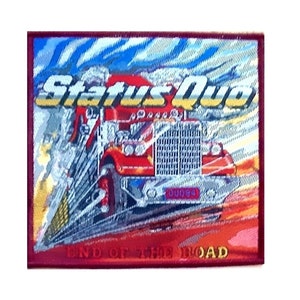 May include: A red, white, and blue embroidered patch with the text "Status Quo" and a red semi-truck with the text "End of the Road" below the truck.