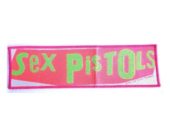 SEX PISTOLS - woven strip sew on patch, official .   Punk rock official patch.  Bright pink and green colours