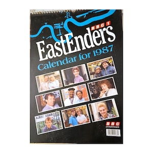 May include: A vintage 1987 EastEnders calendar. The cover is black with the show's logo in white and blue. It features images of the cast and the text "Calendar for 1987". The BBC Enterprises logo is in the bottom right corner.