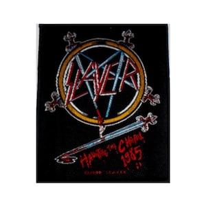 May include: Black and white embroidered patch with a red and blue Slayer logo in a yellow circle. The text "Haunting the Chapel 1985" is embroidered in red below the logo.