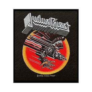 May include: Black and red iron-on patch featuring a stylised image of a flying eagle and the text "Judas Priest" in white. The patch has a red, yellow and orange circle around the eagle.