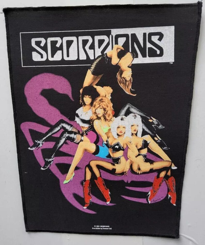 May include: Black patch with the band name "SCORPIONS" in white above a graphic of women in various poses. A large purple scorpion tail design is also present.