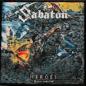 May include: A black and white embroidered patch featuring the band name "Sabaton" in a large, bold font. The patch depicts a stylised image of a soldier holding a sword, set against a backdrop of a battlefield scene. The text "Heroes" is printed beneath the band name, with the copyright symbol and the year "2014" and the band name "Sabaton" printed below the text.