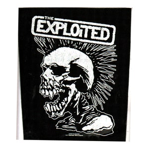 May include: Black and white iron-on patch featuring a skull with a mohawk and the text "The Exploited" in a white rectangle.