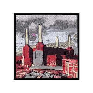 May include: An embroidered patch depicting a power station with tall chimneys against a cloudy sky, in shades of red and grey. The text "©2001 PINK FLOYD MUSIC LTD. (P) & © 2001 BY ANTHILL" is at the bottom of the patch.