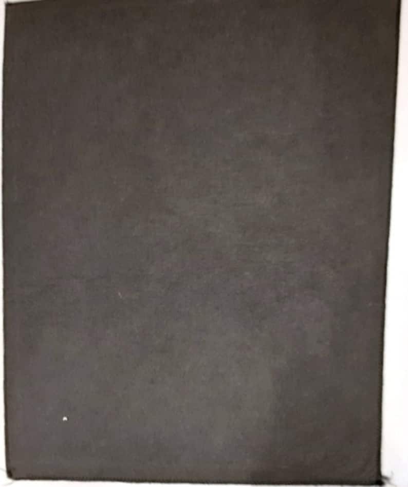 May include: A dark grey, textured, rectangular piece of fabric.