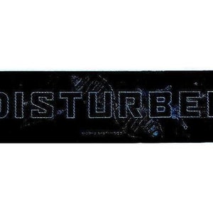 May include: Black and white rectangular patch with the word "DISTURBED" in white outlined letters.