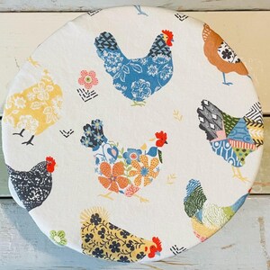 Reusable bowl covers in "Boho Chickens" print, featuring a repeating pattern of colorful chickens on a cream fabric. The chickens are decorated with floral and geometric designs in shades of blue, yellow, orange, and black.