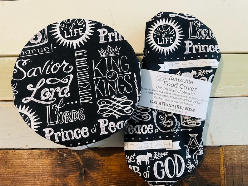 Reusable bowl covers in "Names of Jesus" print.  Black background fabric with white lettering and designs, proclaiming Jesus's names including: Savior, Lord, Bread of Life, Prince of Peace, Lamb of God, King of Kings.