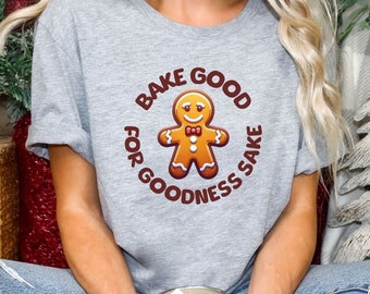 May include: A gray t-shirt with a gingerbread man graphic and the text "Bake for Goodness Sake".