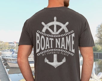May include: A black t-shirt with a white anchor, a steering wheel, and the text "BOAT NAME MY FAVORITE PLACE" printed on the back.