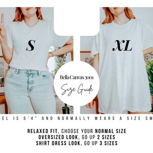 May include: A size guide for Bella Canvas 3001 t-shirts. The image shows two people wearing the t-shirts, one in size S and the other in XL. Text on the image provides sizing recommendations: relaxed fit, choose your normal size; oversized look, go up 2 sizes; shirt dress look, go up 3 sizes.