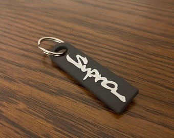 Supra car keychain black and white.