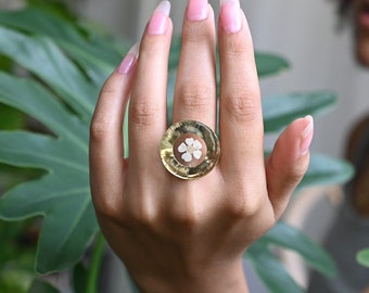 Extravagant floral resin ring with a dried white blossom flower