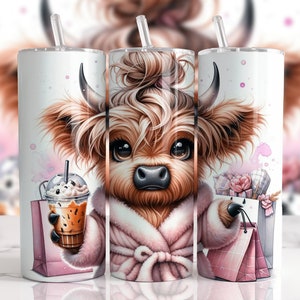 May include: A white tumbler with a cartoon illustration of a Highland cow wearing a pink robe and holding a shopping bag and a iced coffee. The cow has brown fur, a pink nose, and a brown and white face. The tumbler has a clear lid and a straw.