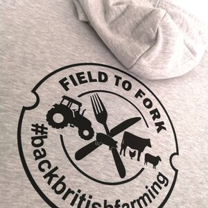 May include: Gray hooded sweatshirt with a black circular logo that says "Field to Fork #backbritishfarming" with a tractor, fork, knife, pig, cow, and chicken inside the circle.