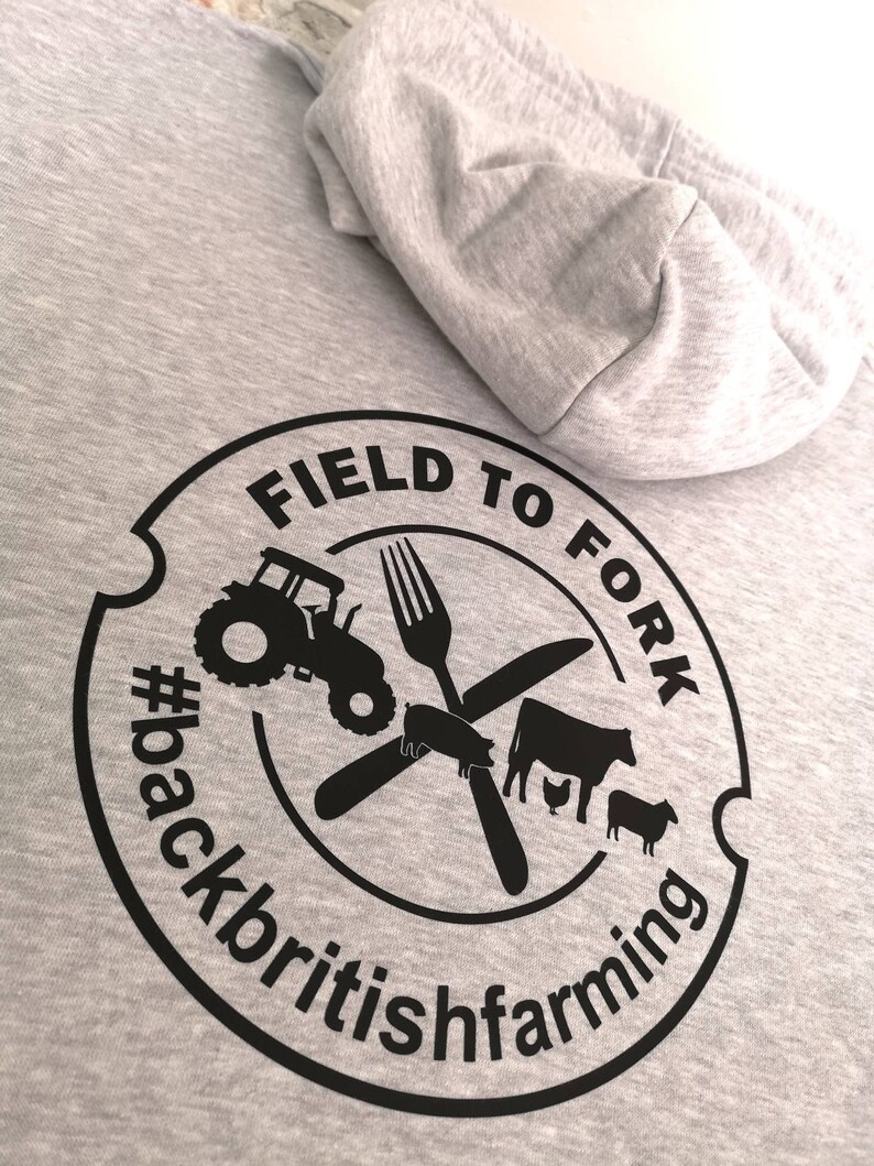 May include: Gray hooded sweatshirt with a black circular logo that says "Field to Fork #backbritishfarming" with a tractor, fork, knife, pig, cow, and chicken inside the circle.