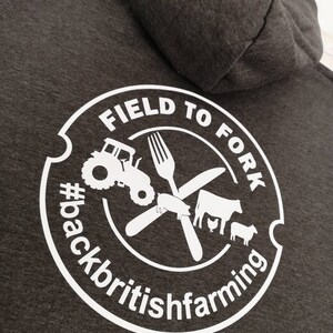 May include: Gray hooded sweatshirt with a white circle logo that says "Field to Fork #backbritishfarming". The logo includes a tractor, a fork, a knife, a pig, a cow, a chicken, and a sheep.