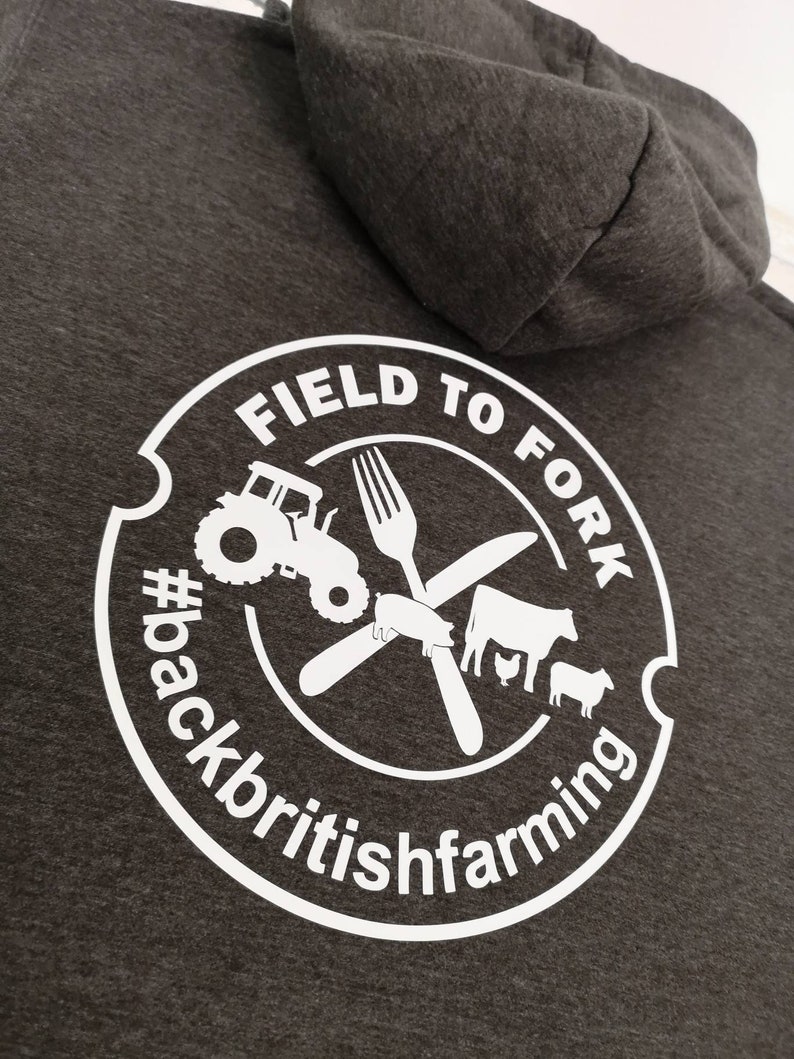 May include: Gray hooded sweatshirt with a white circle logo that says "Field to Fork #backbritishfarming". The logo includes a tractor, a fork, a knife, a pig, a cow, a chicken, and a sheep.