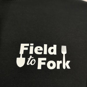 May include: Black hoodie with a white graphic that says "Field to Fork" with a shovel and fork icon.