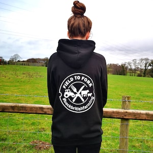 May include: Black hoodie with a white logo that says "Field to Fork #backbritishfarming" with a tractor, fork, knife, cow, and chicken graphic.