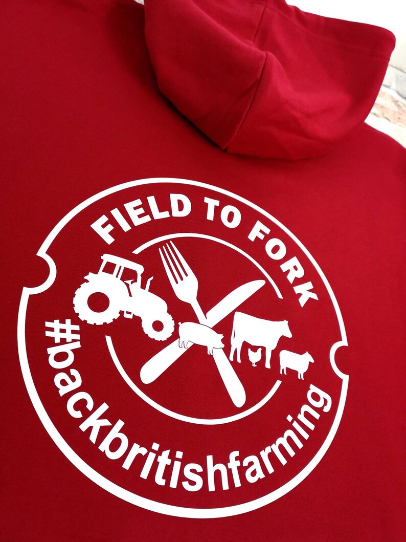 May include: Red hooded sweatshirt with a white circle logo that says "Field to Fork #backbritishfarming" with a tractor, fork, knife, pig, cow, chicken, and sheep inside the circle.